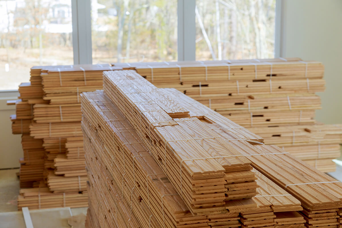 Stacks of fresh-cut timber planks ready for use on a construction project