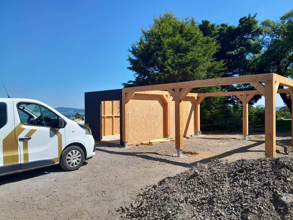Farragon Joinery van parked beside car port structure with OSB panels being fitted to the end wall