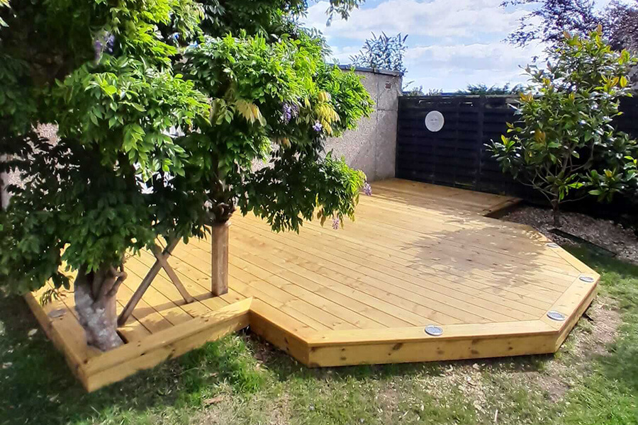 Bespoke octagonal timber garden decking with integrated tree surround and recessed deck lights