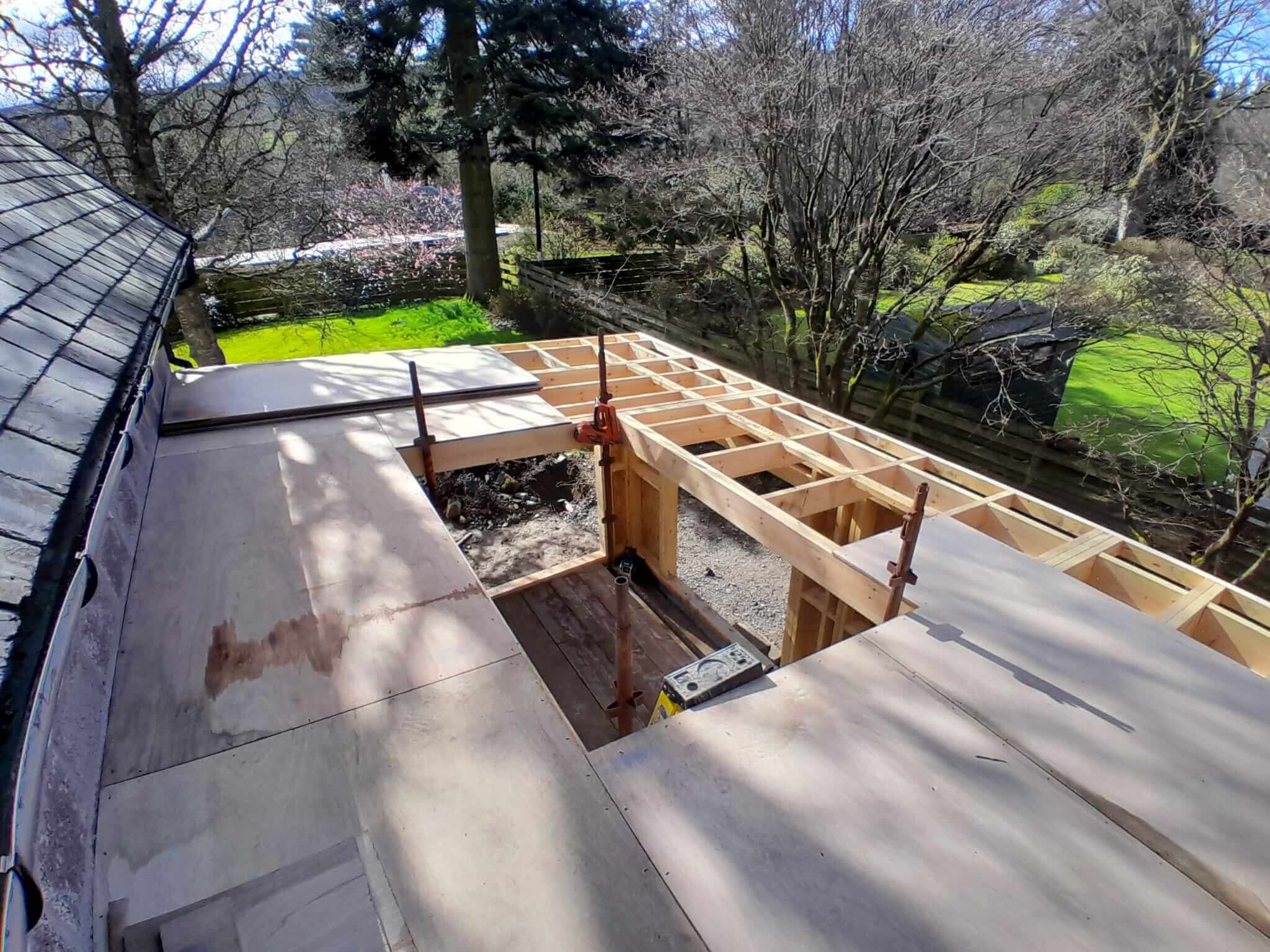 Ecotherm insulation boards being laid on flat roof around bespoke rooflight opening, Weem