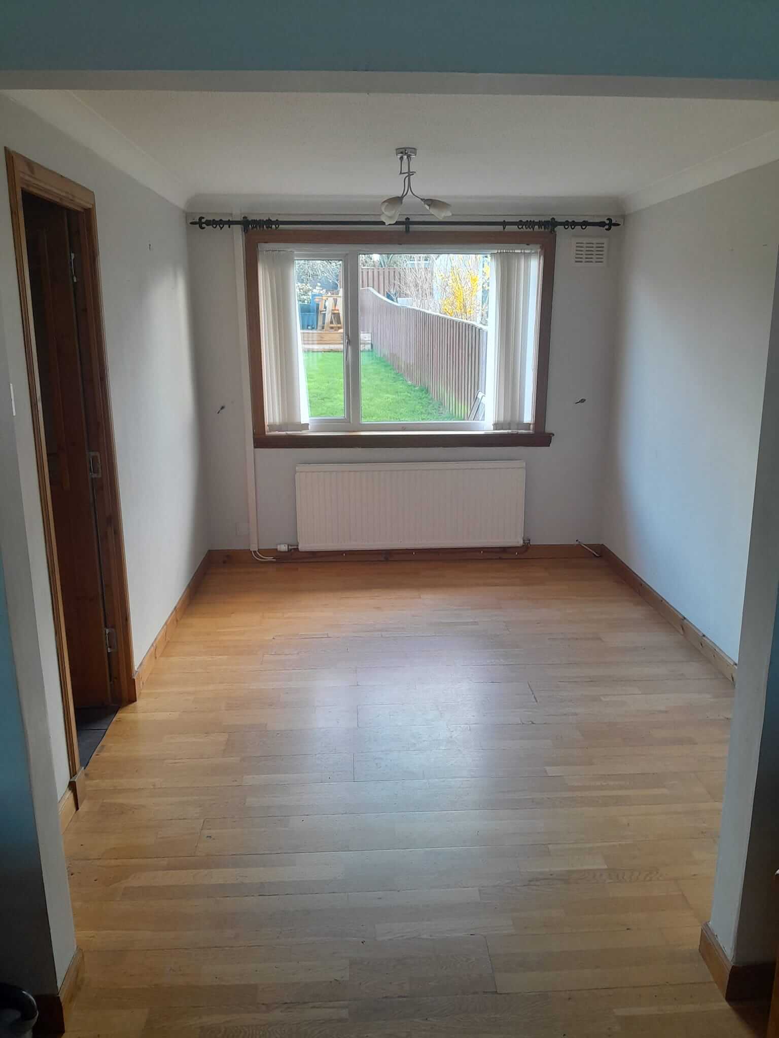 Original separate dining room before open-plan conversion — empty room with laminate flooring